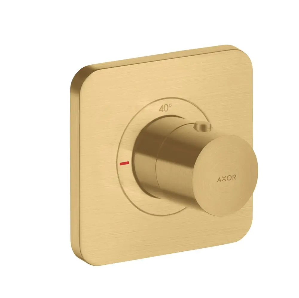 Thermostat-Drehknopf in gebürsteter Goldoptik von AXOR, montiert auf einer quadratischen Wandplatte mit Temperaturanzeige und Markierung.